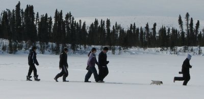 Walking along the frozen lake with a pup.