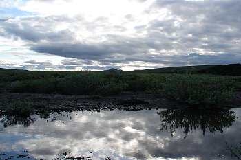Near perfect image in the water of the land and sky.