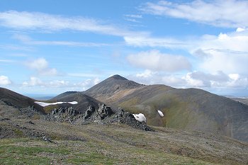 Some jagged rocks on top of a mountain.