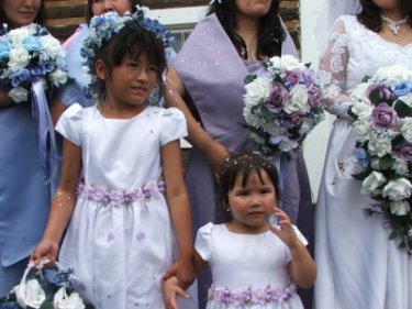 Flower girls Willow and River Frost looking a little bit confused.