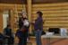 Marion Schafer presenting gift of appreciation to researcher and co-author Shirleen Smith. The gift is a pair of beaded slippers made by Elizabeth Kaye and her daughter Marla Charlie, a framed beading by Sherrie Frost and a set of Old Crow Olympic Torch Relay hat, mitts and scarf.