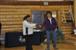 Ida Tizya receiving her uncle Andrew Tizya's album on behalf of her family.