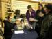 Community members lining up to pick up household copies of ''People of the Lakes'', purchase extra copies and sign up for copies of the photo album.