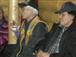 Stanley Njootli Sr in his beaded vest sitting beside Elder Joel Peter.